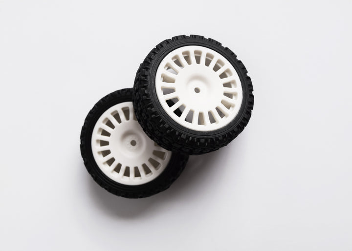 A 4-piece rally tyre set with block-type tread, 18 spokes, and 25/66mm wheels, including wheel spacers