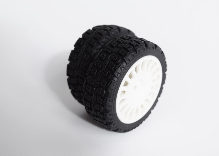 A 4-piece rally tyre set with block-type tread, 18 spokes, and 25/66mm wheels, including wheel spacers