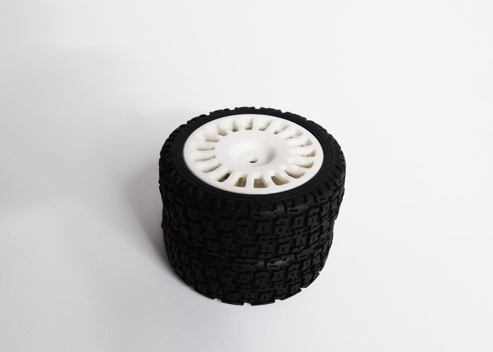 A 4-piece rally tyre set with block-type tread, 18 spokes, and 25/66mm wheels, including wheel spacers